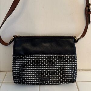 Black FOSSIL crossbody with brown adjustable strap.